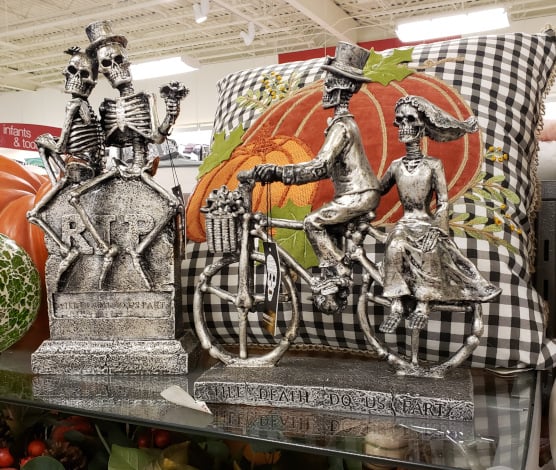 Skeleton couples on a tombstone and on a bike